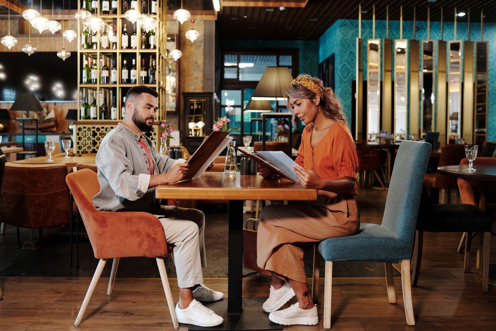 Couple reviewing the menu together at a stylish restaurant on a date