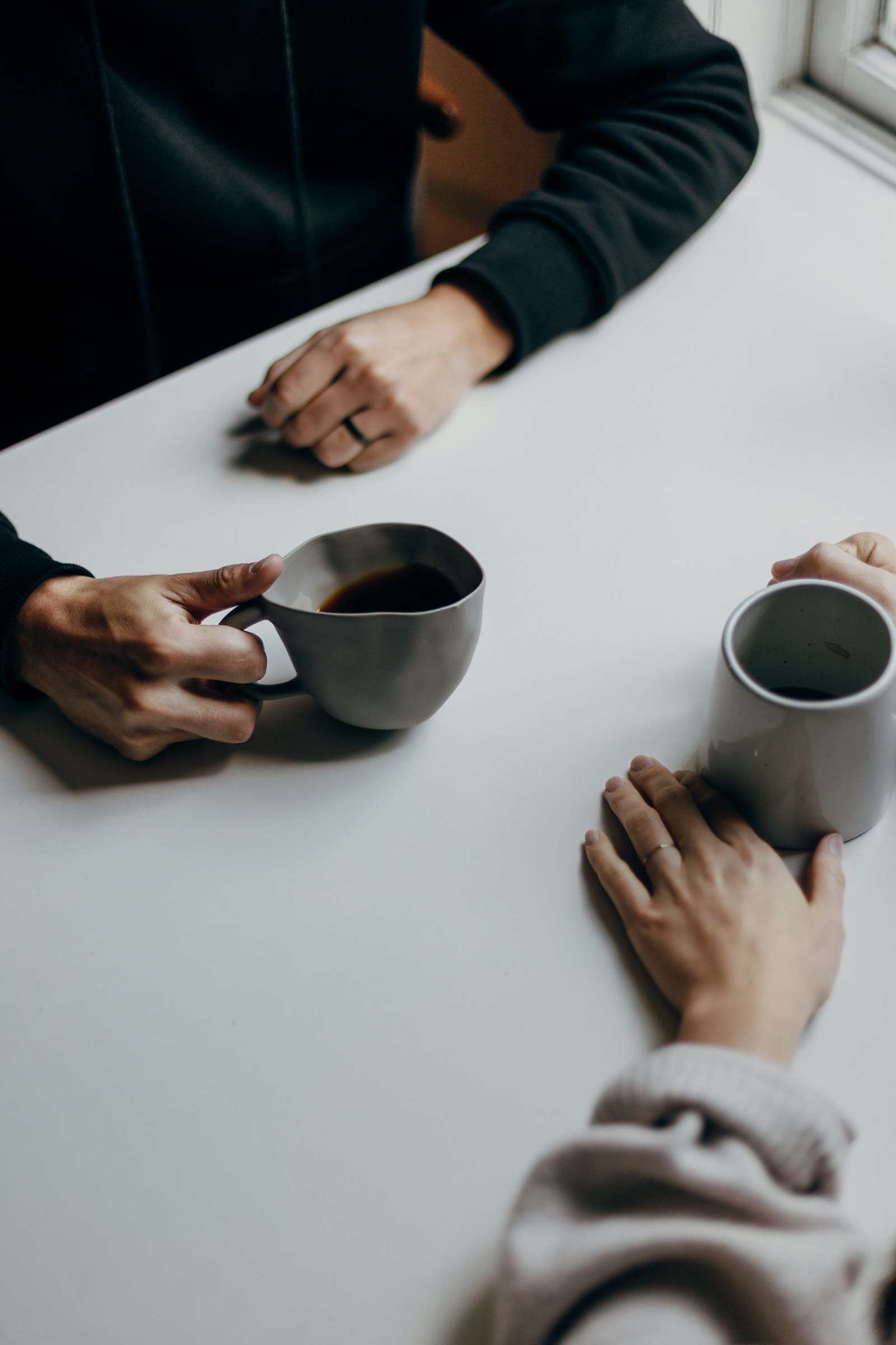 Couple sitting together over coffee, talking and connecting on a date