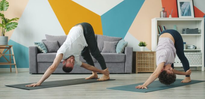 Couple stretching and practicing mobility exercises together
