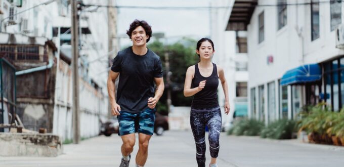 Couple jogging outdoors together to stay active while dating
