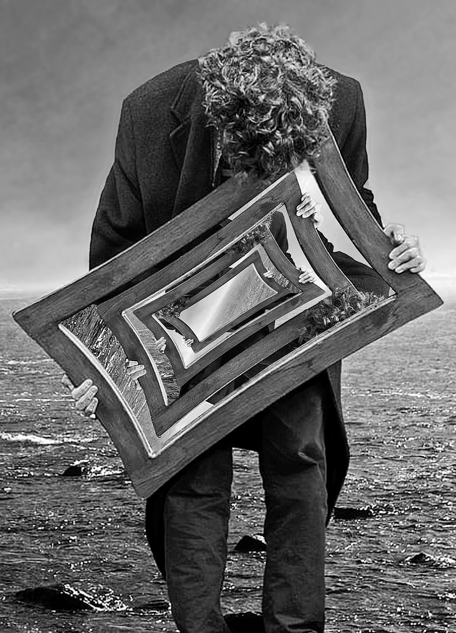 Man looking at his own reflection in a mirror, representing an honest self-assessment of confidence and testosterone