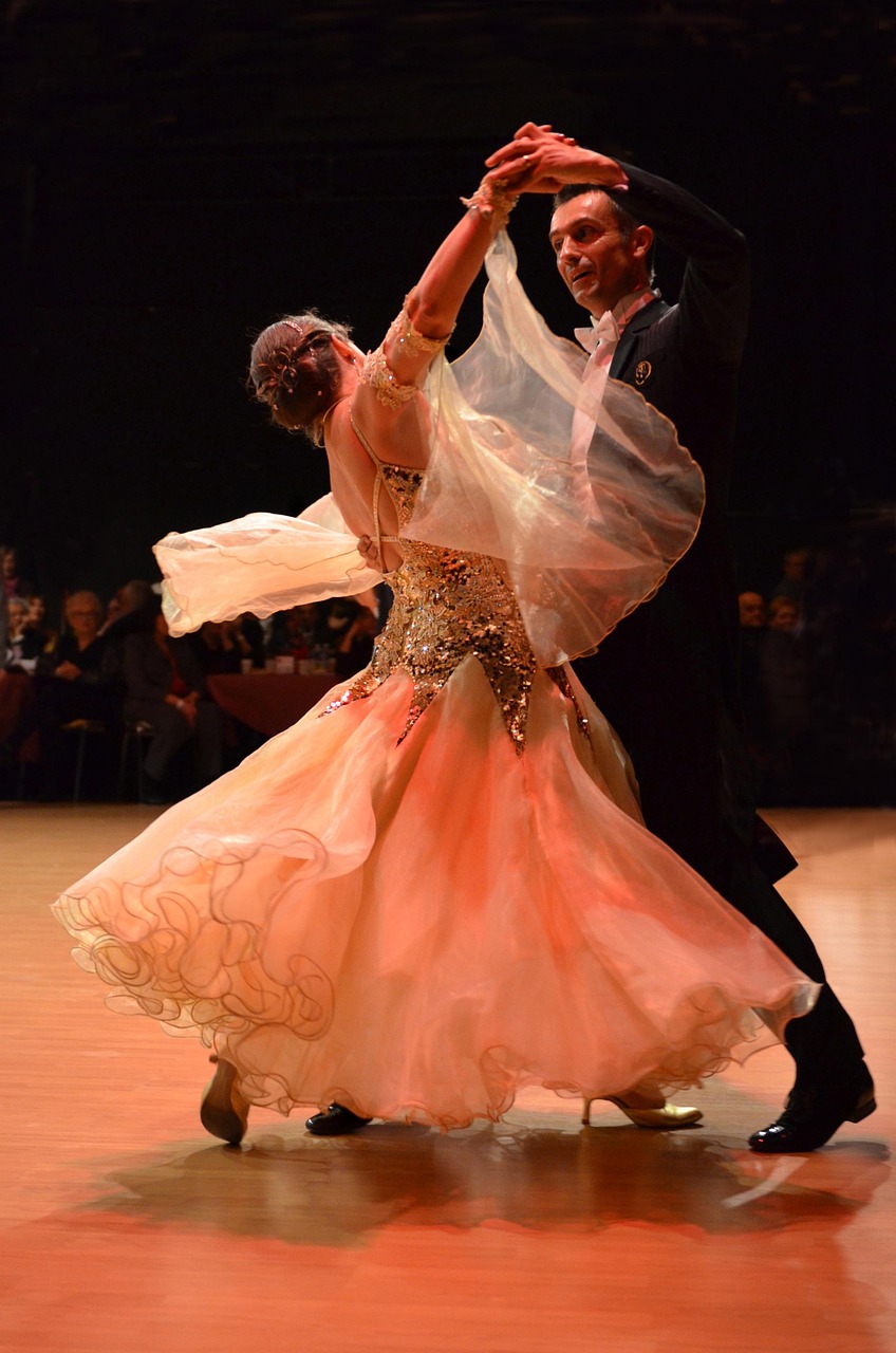 Couple in a ballroom dance hold, one partner leading and one following, illustrating the trust behind dominant and submissive roles in kink