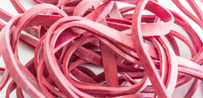 A stretched rubber band, symbolizing the tension edging builds by approaching release and pulling back again and again
