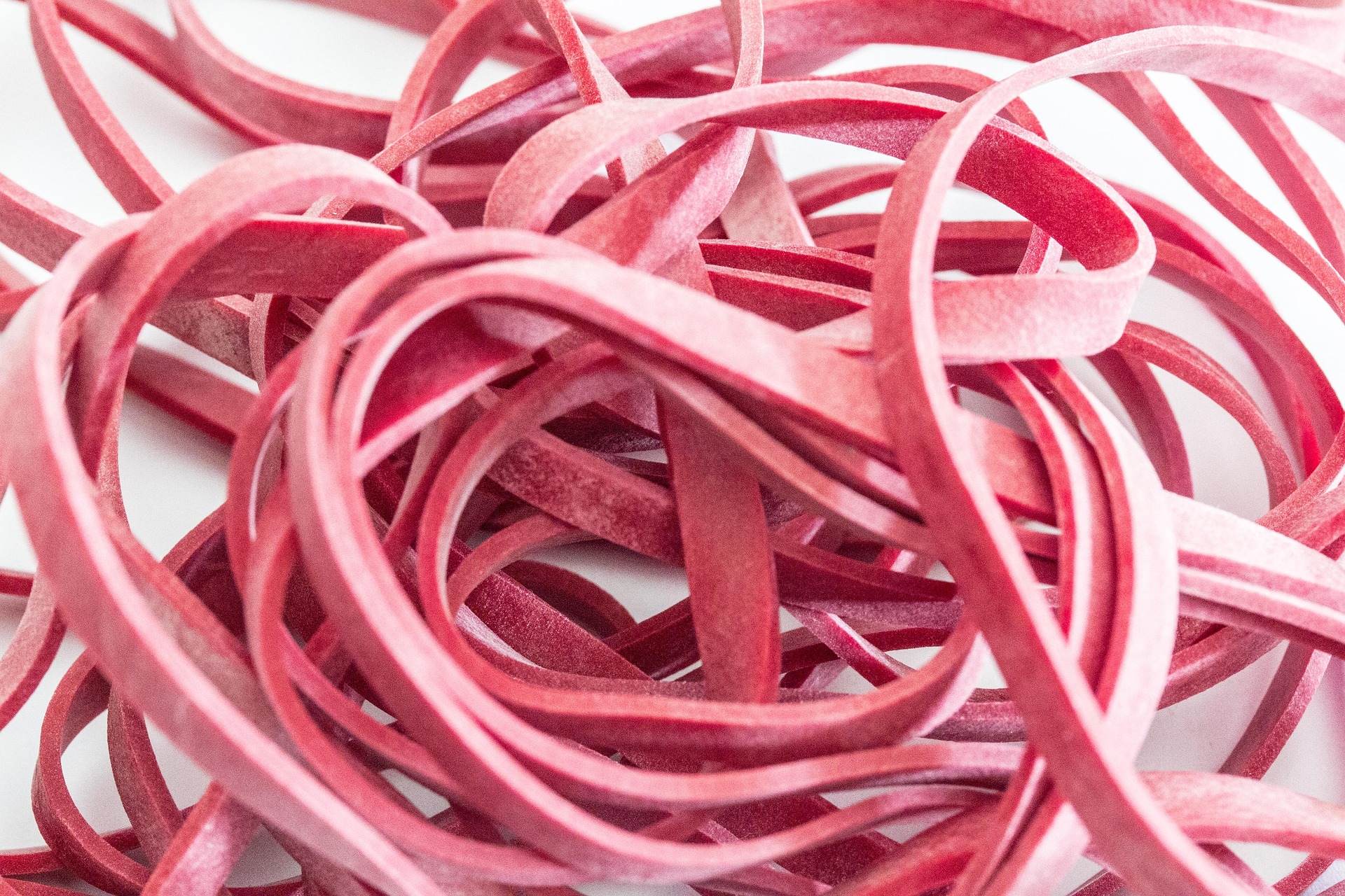 A stretched rubber band, symbolizing the tension edging builds by approaching release and pulling back again and again