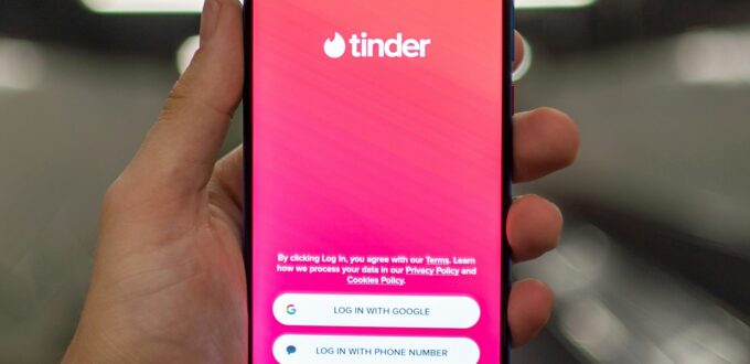 A person holding a smartphone showing a dating app, the starting point for vetting a match before the first date